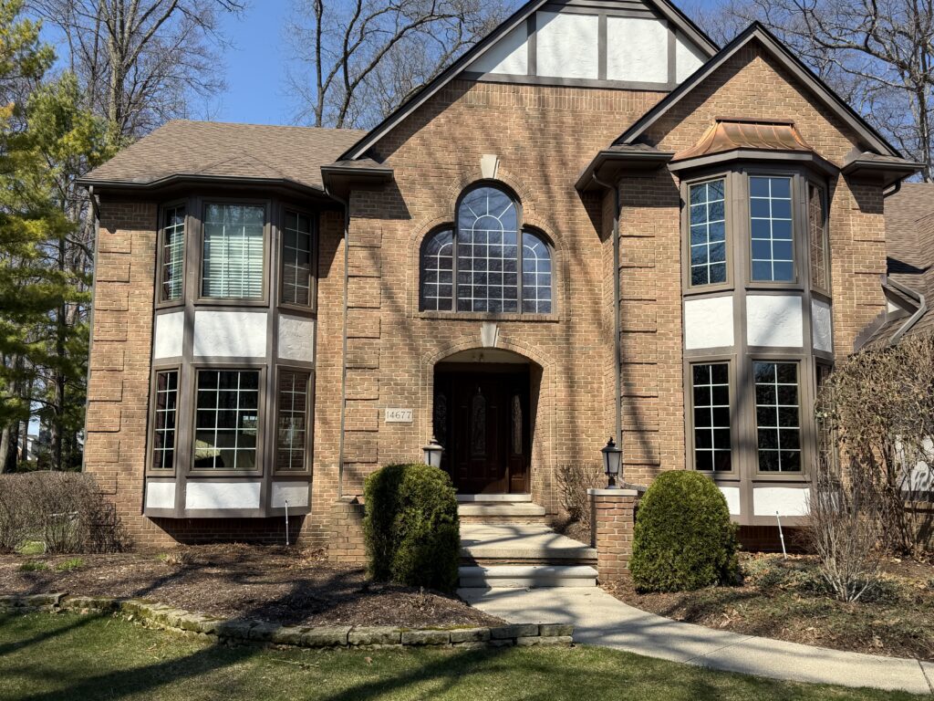 Front of home with new entry door and windows