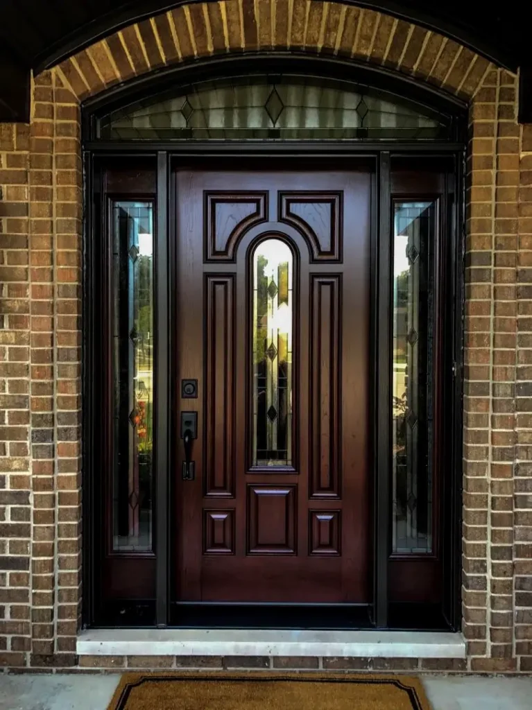New wood entry door with decorative glass, sidelights, and transom