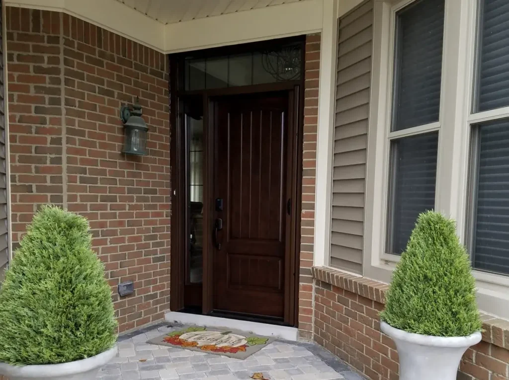 New wood entry door with decorative glass sidelight and transom