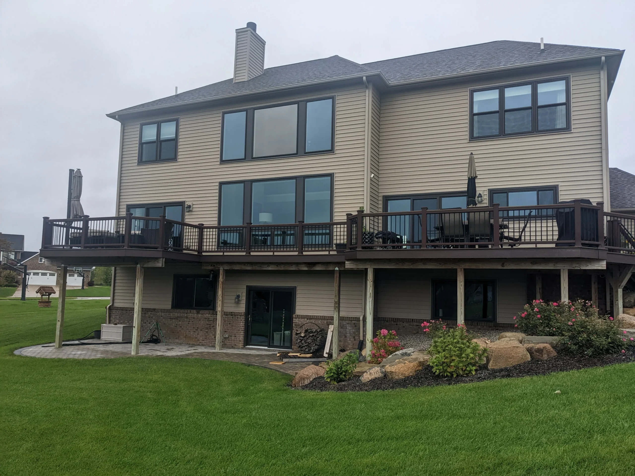 Back of home with all new windows and sliding patio doors