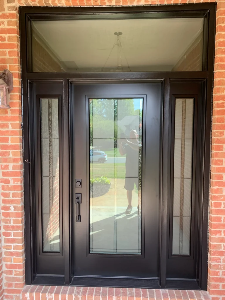 New entry door with decorative glass, sidelights, and transom