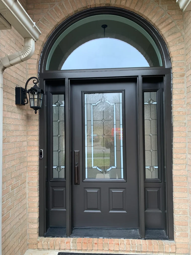 New entry door with decorative glass, sidelights, and transom