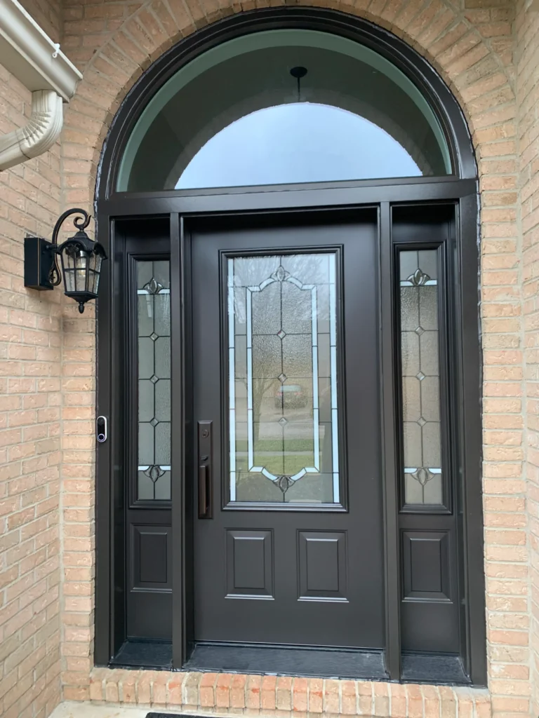 New entry door with decorative glass, sidelights, and transom