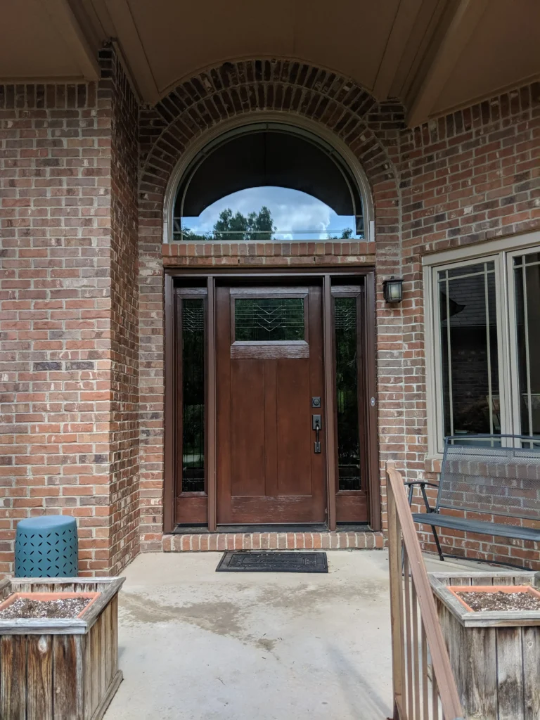 New wood entry door with decorative glass, sidelights, and transom