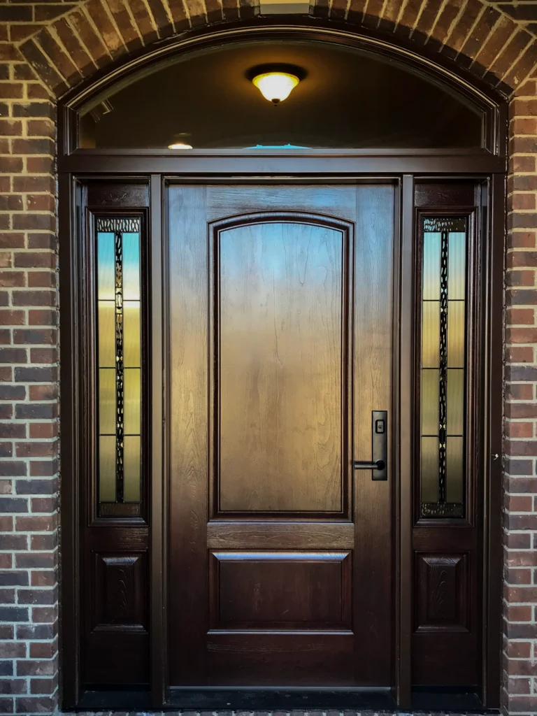 New wood entry door with decorative glass sidelights and transom