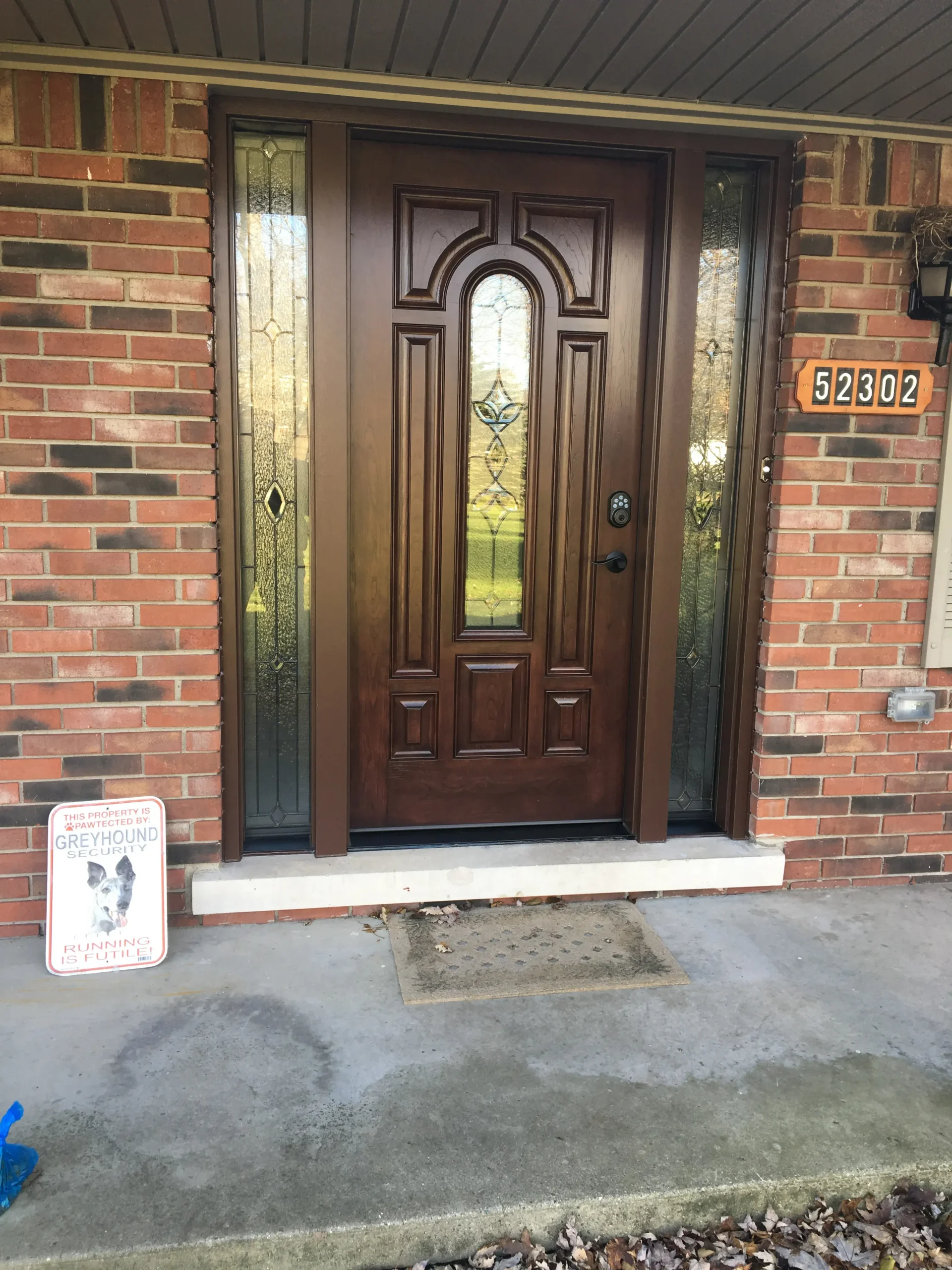 New wood entry door with decorative glass and sidelights