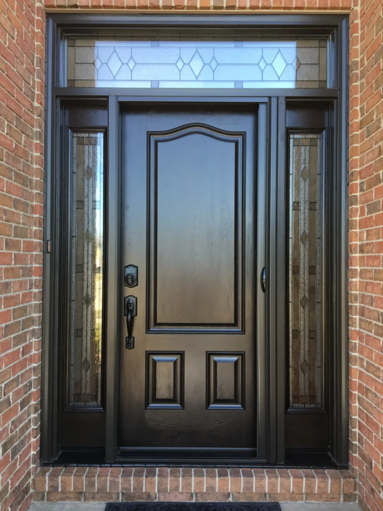 New wood entry door with decorative glass sidelights and transom
